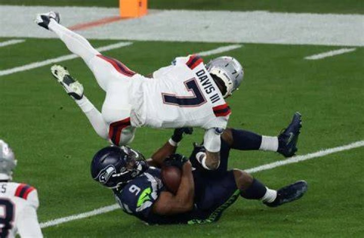 The Rivalry Renewed: Patriots And Seahawks Players Clash For Victory